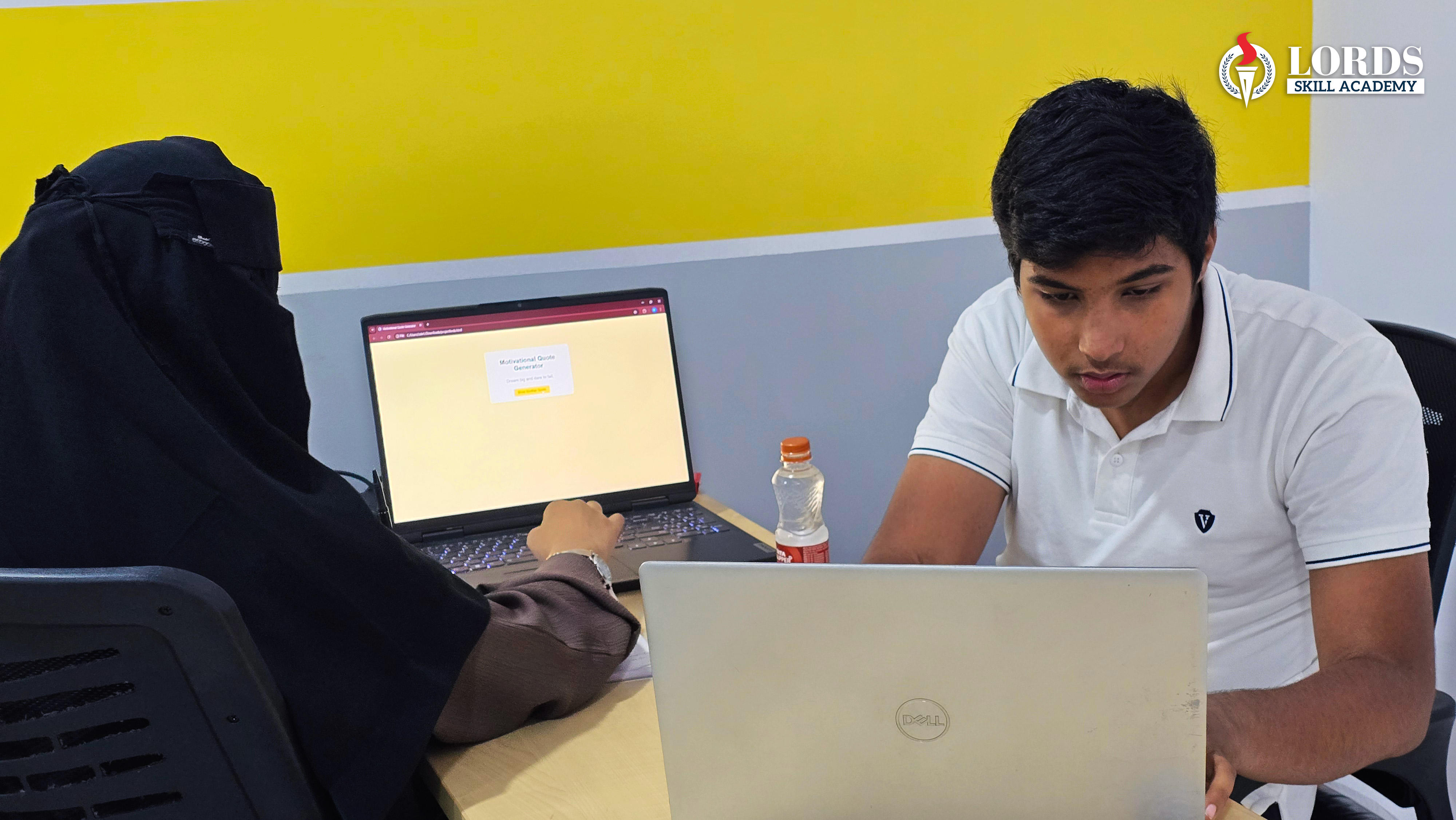 Students collaborating on programming projects in modern coding lab